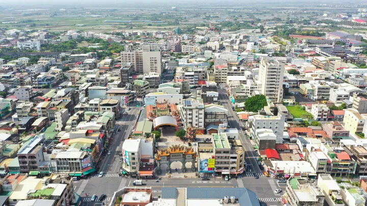 Aerial view of a dense town center with a temple complex in Syuejia District, Tainan