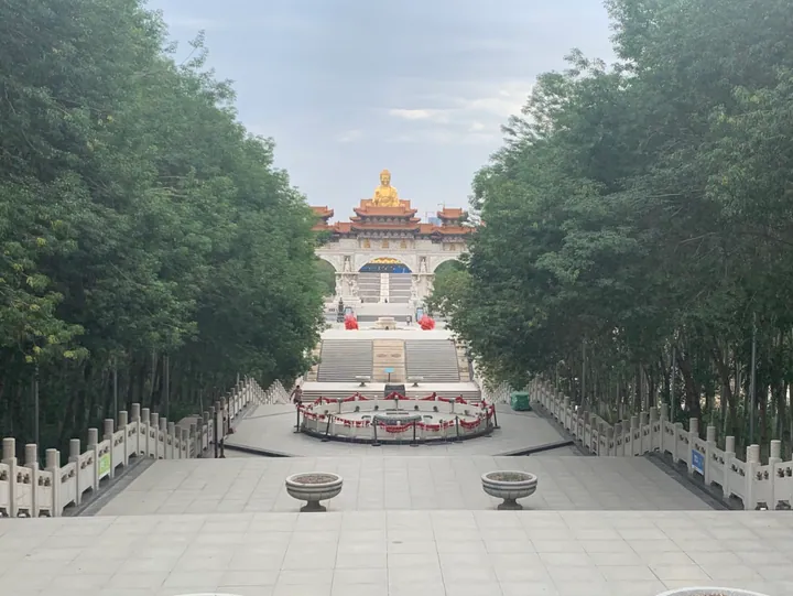 Golden Buddha statue and temple complex on Hongguang Mountain