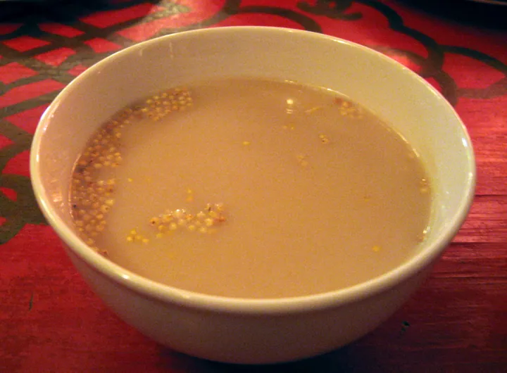 A bowl of tan-colored Mongolian salted milk tea.