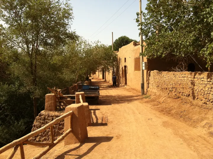 Dirt lane between mudbrick houses in Mazha Village