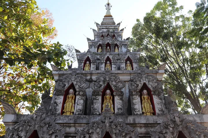 Ornate white and gold Theravada Buddhist pagoda tower