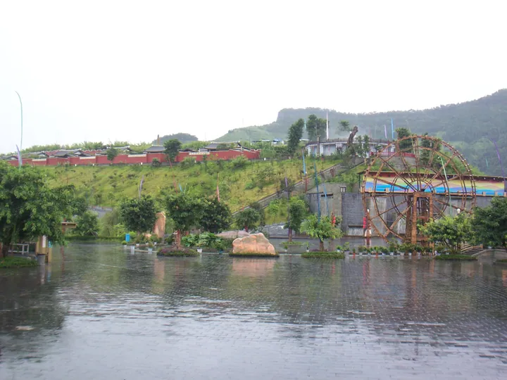 Resort plaza with a large decorative waterwheel at Xibu Daxiagu hot springs
