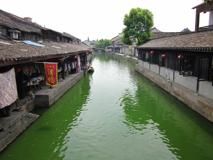 Canal lined with traditional houses and red lanterns in Anchang ancient town, Keqiao District, Zhejiang