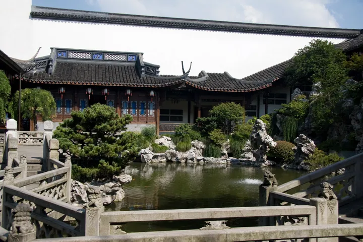 Traditional courtyard garden with a pond, rockery, and pavilion at Hu Xueyan's former residence
