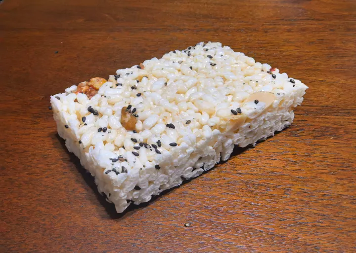 Block of Jiangjin puffed-rice candy studded with black sesame seeds