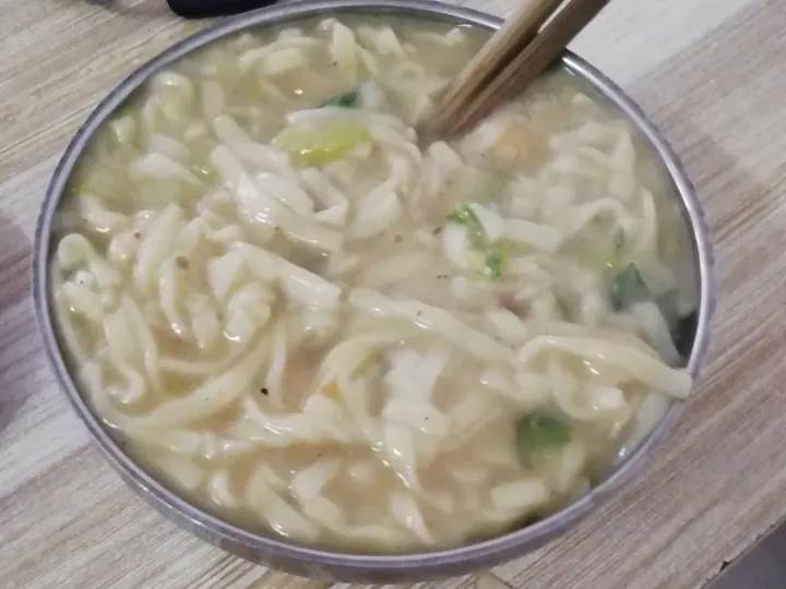 Bowl of Henan hu tu mian noodles in thick broth with chopsticks