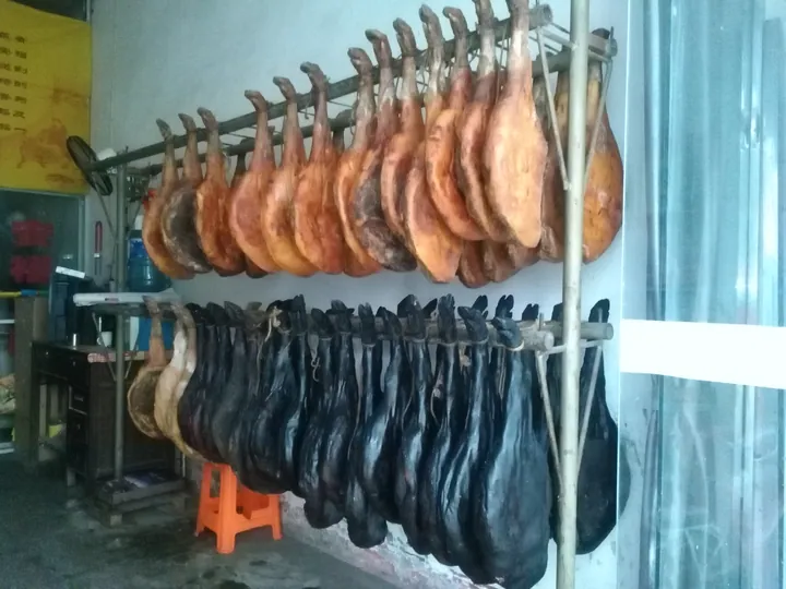 Rows of cured ham legs hanging to dry in Anfu County.
