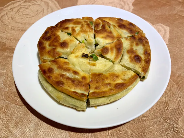 Sliced scallion pancake on a plate at a Taipei restaurant