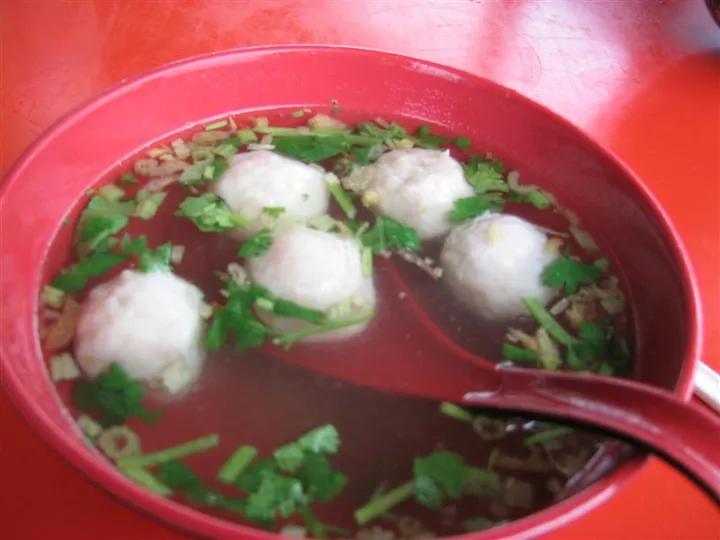 Bowl of pork ball soup with cilantro and scallions