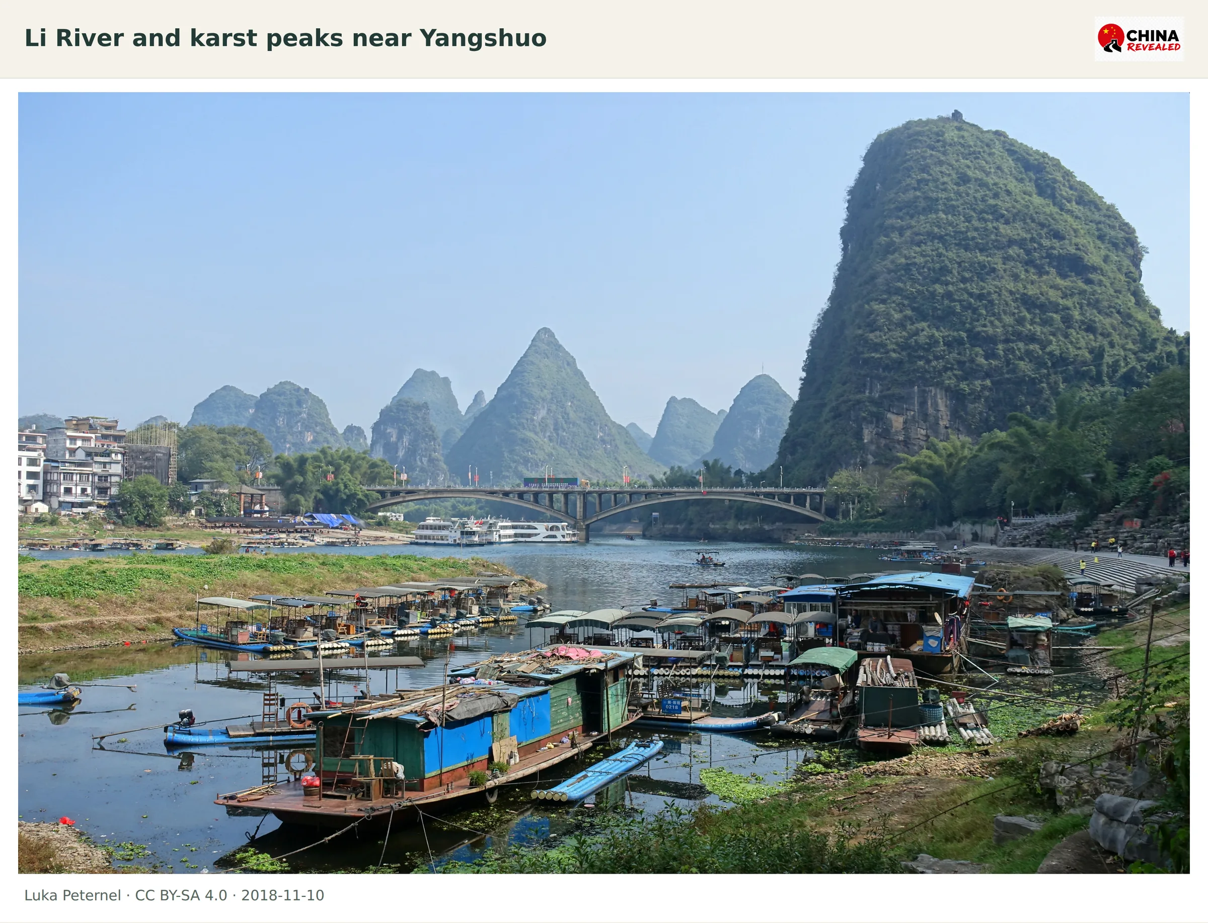 Karst peaks rise behind boats on the Li River near Yangshuo