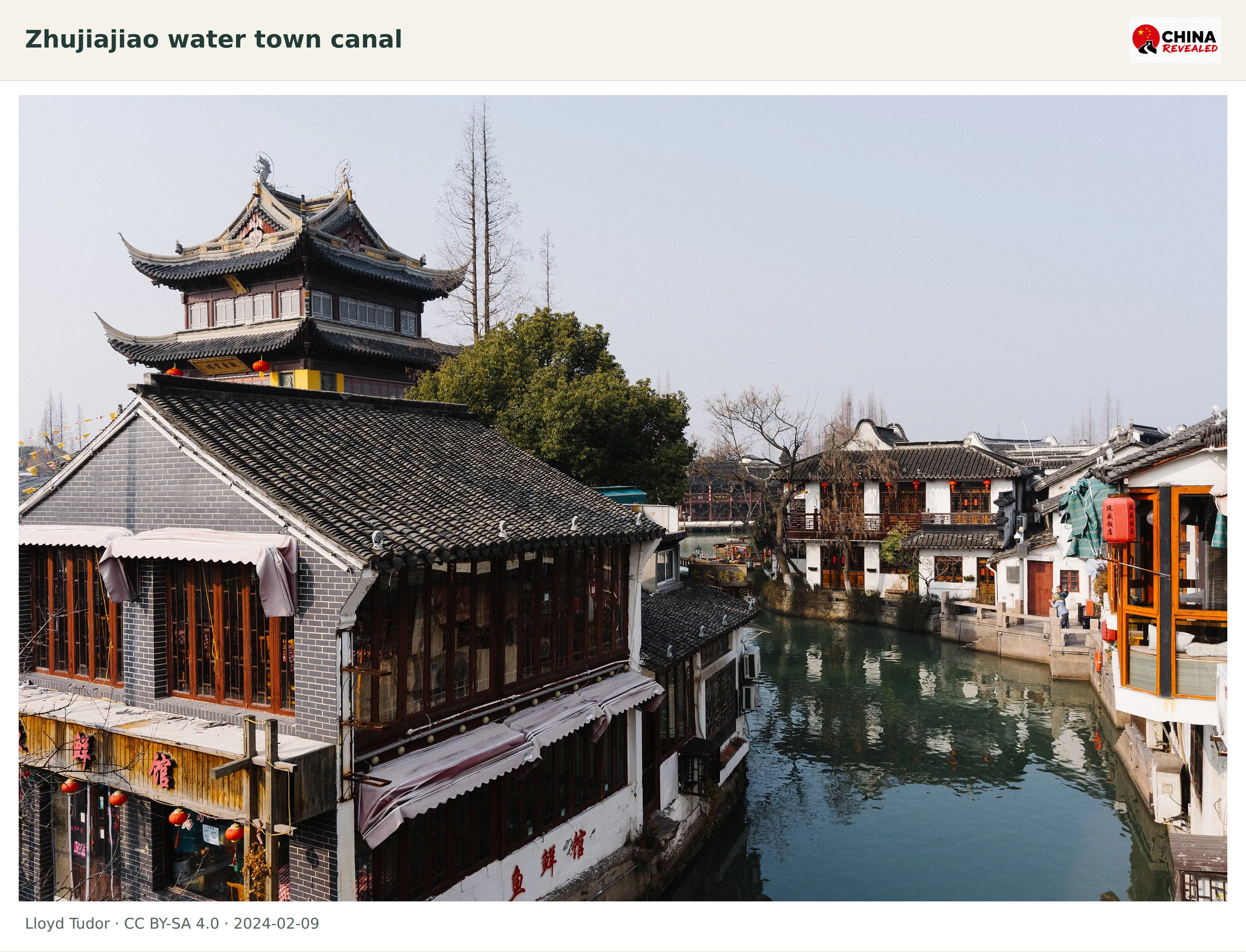 Traditional tiled buildings and a pavilion beside a canal in Zhujiajiao near Shanghai