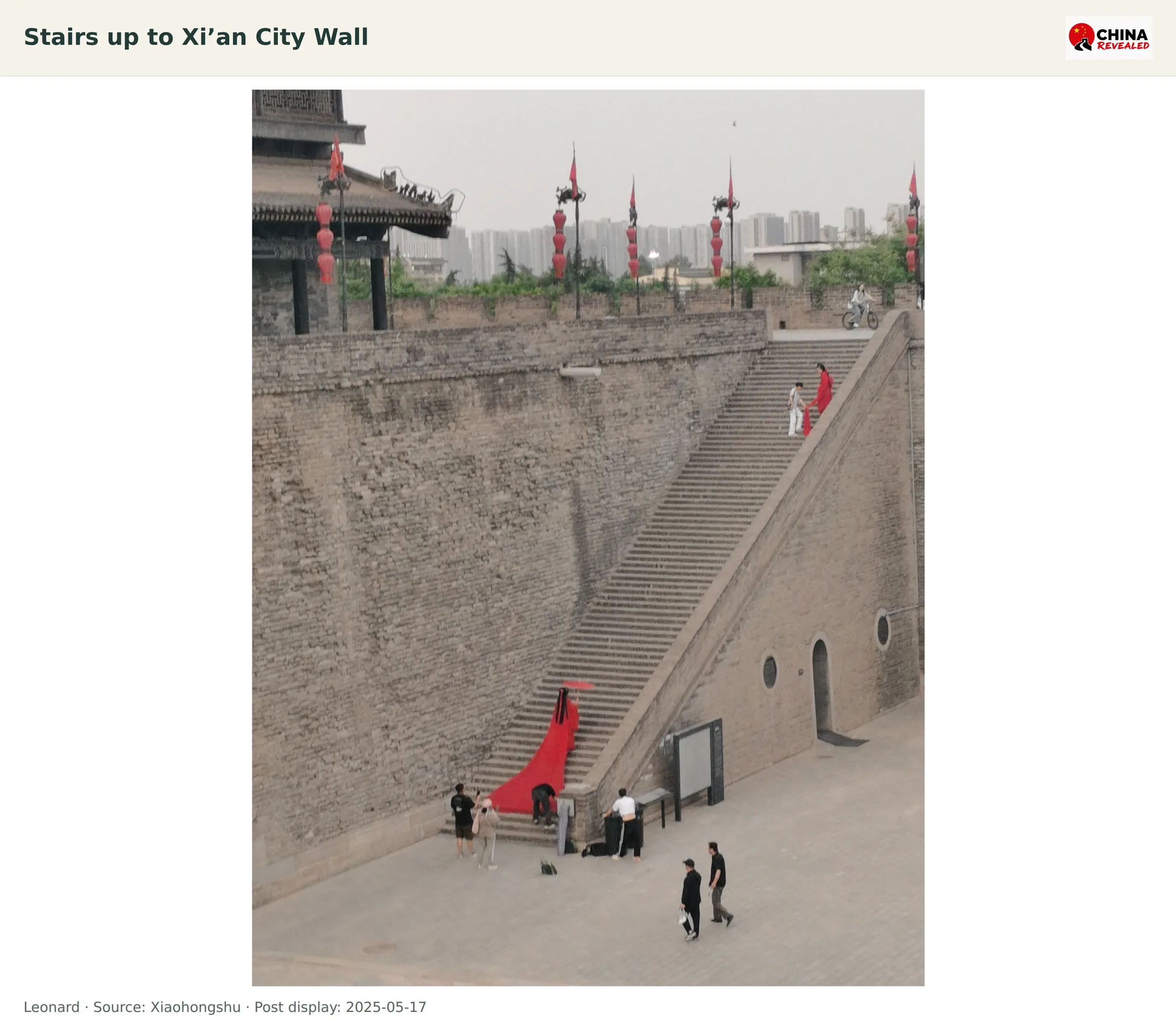A broad stone staircase leading up to the Xi’an City Wall with visitors at the bottom