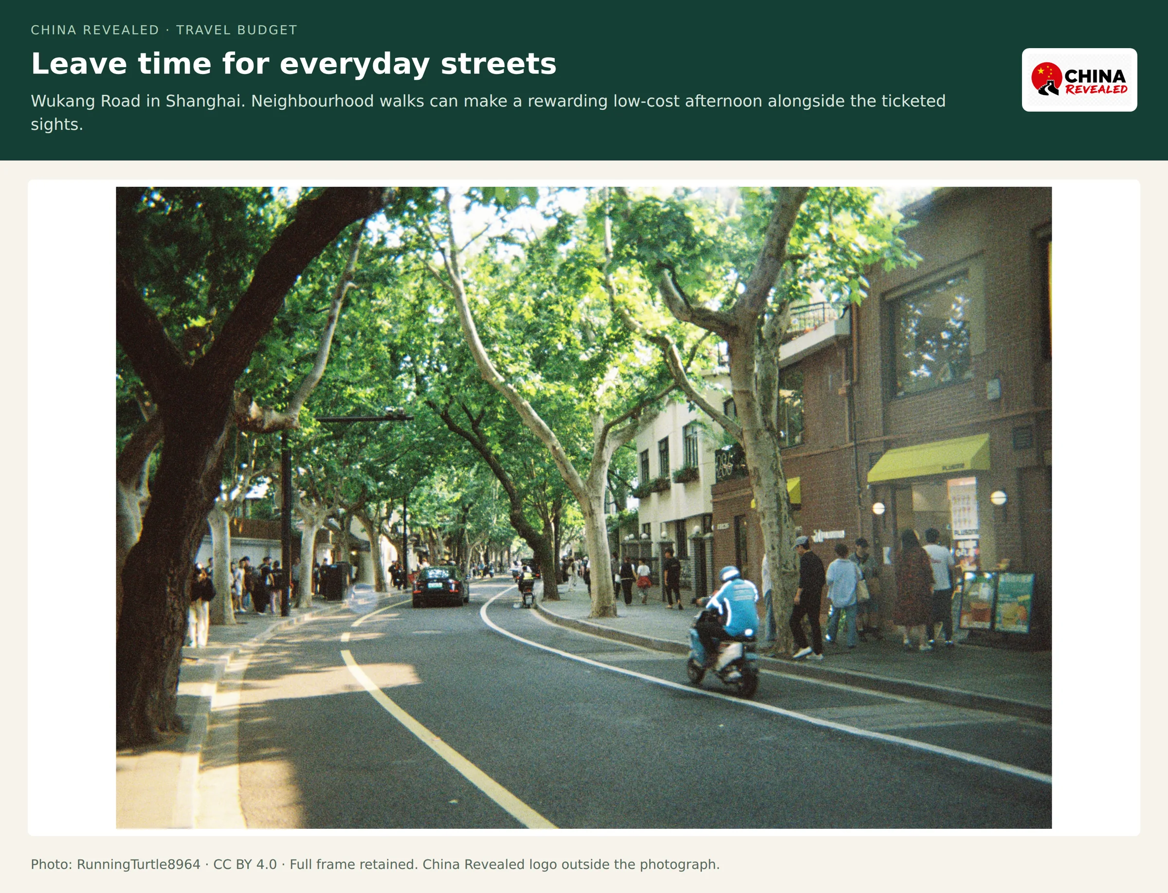 Plane-tree-lined Wukang Road with scooters, pedestrians and small shops in Shanghai's former French Concession